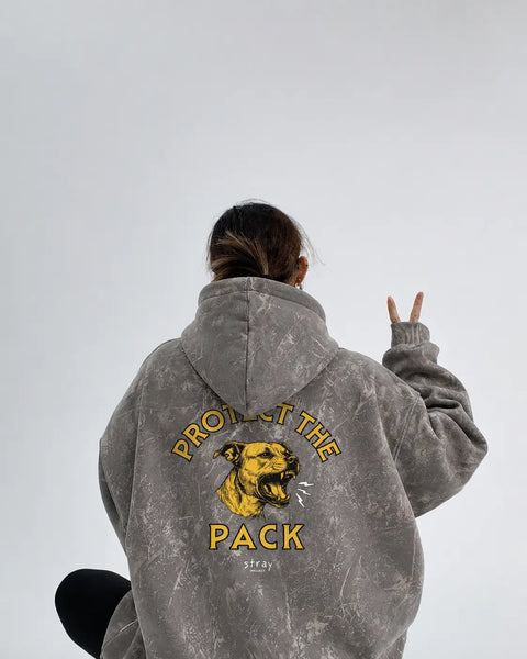 Close-up of Protect The Pack camo hoodie sleeve and graphic print texture