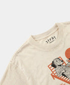 Beige t-shirt with a graphic design and 'Stray' branding on a light gray background