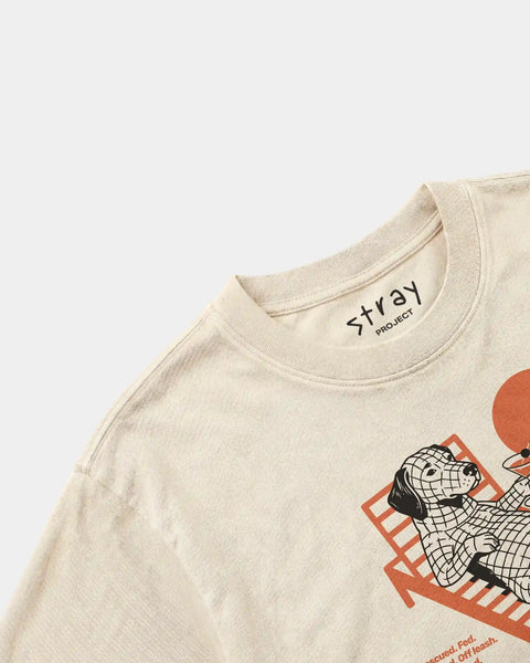 Beige t-shirt with a graphic design and 'Stray' branding on a light gray background