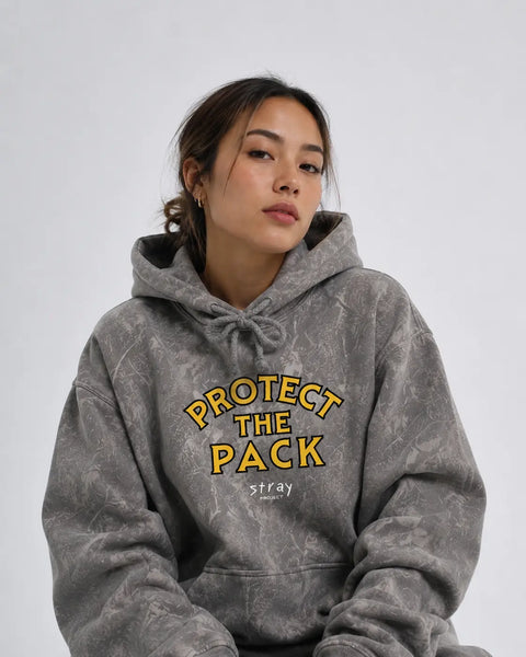 Back view of the Protect The Pack limited camo hoodie on a model outdoors